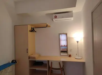 a room with a desk with a lamp and a window at IFS SoHo Basic Homestay Entire Home in Seri Iskandar