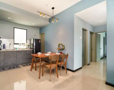 a kitchen and dining room with a wooden table and chairs at 3 Bedroom Izz Homestay Casa kayangan in Ipoh