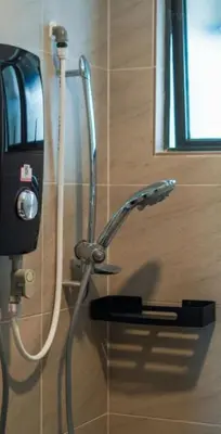 a shower in a bathroom with a shower head at 3 Bedroom Izz Homestay Casa kayangan in Ipoh