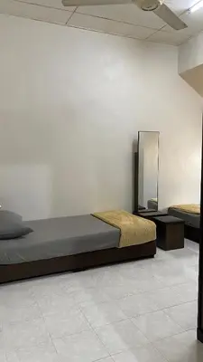 a bedroom with a bed and a mirror on the wall at Imtiyaz Islamic Homestay in Kulim
