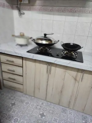 a stove top with two pans on top of it at Imtiyaz Islamic Homestay in Kulim