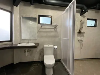 a bathroom with a toilet and a sink at Cameron Highland Retreat in Tanah Rata