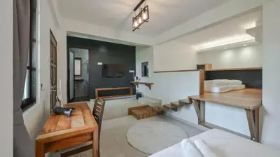 a bedroom with a bed and a desk and a sink at Cameron Highland Retreat in Tanah Rata