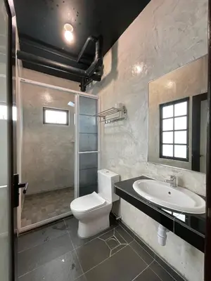 a bathroom with a toilet and a sink and a shower at Cameron Highland Retreat in Tanah Rata