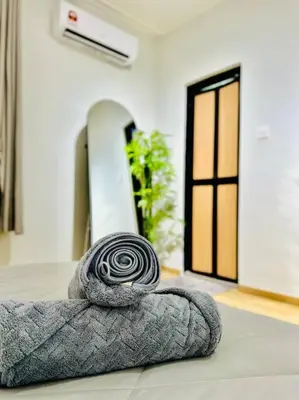 a spiralling grey rug sitting on the floor in a room at My Muji Homestay I Massage Chair I Wifi 500 Mbps in Seri Manjung
