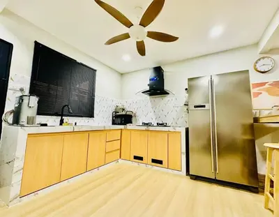 a kitchen with a refrigerator and a ceiling fan at My Muji Homestay I Massage Chair I Wifi 500 Mbps in Seri Manjung