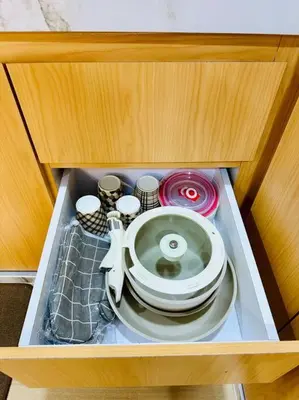 a cabinet with a plate and dishes in it at My Muji Homestay I Massage Chair I Wifi 500 Mbps in Seri Manjung