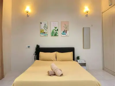 a bedroom with a large bed with two pillows on it at CozyHouse 4ROOM 3BATH ROOM 10PAX```SimpangAmpatTasek in Simpang Ampat