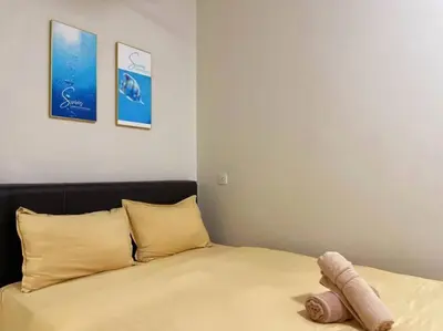 a bed with a stuffed animal laying on top of it at CozyHouse 4ROOM 3BATH ROOM 10PAX```SimpangAmpatTasek in Simpang Ampat