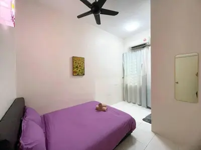 a purple bed in a room with a ceiling fan at CozyHouse 4ROOM 3BATH ROOM 10PAX```SimpangAmpatTasek in Simpang Ampat