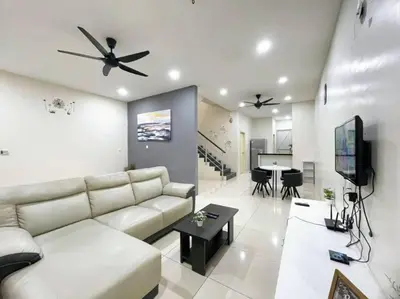 a living room with a couch and a tv and a table at CozyHouse 4ROOM 3BATH ROOM 10PAX```SimpangAmpatTasek in Simpang Ampat