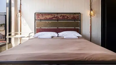 a bed with two pillows on it in a room at Belakang Kong Heng Ipoh Hotel in Ipoh