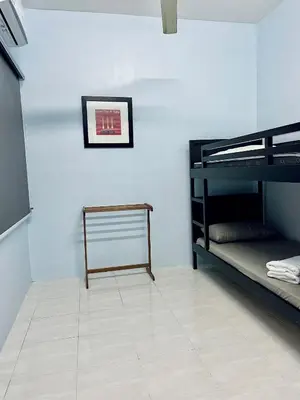 a room with two bunk beds and a picture on the wall at D Ocean Homestay in Seri Manjung