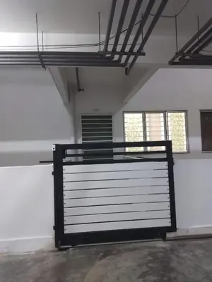 a garage door in a room with two windows at Apartment Cameron Jaya in Tanah Rata