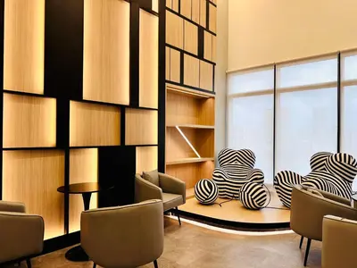 a room with chairs and a table and a window at Luxury Apartment Sea&City View Georgetown 14 pax in Jelutong