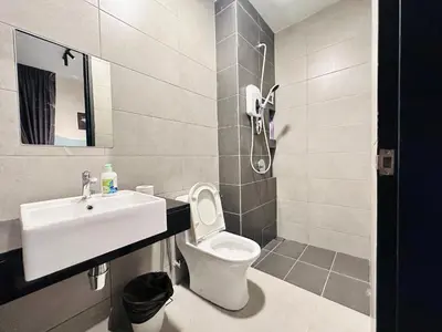a bathroom with a toilet and a sink at Luxury Apartment Sea&City View Georgetown 14 pax in Jelutong