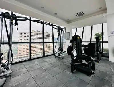 a gym with exercise equipment in a building with windows at Luxury Apartment Sea&City View Georgetown 14 pax in Jelutong