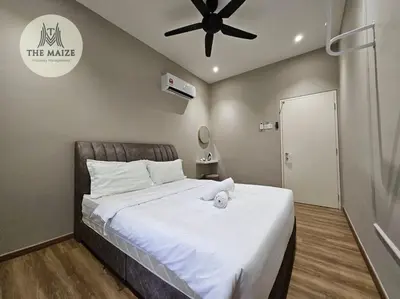 a bedroom with a large bed with a ceiling fan at The Cove Hillside Residence Ipoh - Downtown Delight in Ipoh
