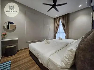 a bedroom with a large bed with a ceiling fan at The Cove Hillside Residence Ipoh - Downtown Delight in Ipoh
