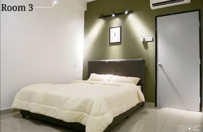 a bedroom with a large bed with a white blanket at Casa Kayangan Meru - Tulip by Goswell in Ipoh