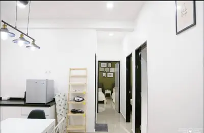a kitchen with white walls and a white counter at Casa Kayangan Meru - Tulip by Goswell in Ipoh