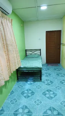 a room with a bed and a door and a tiled floor at Homestay Kak Rose Kuala Lipis in Kuala Lipis