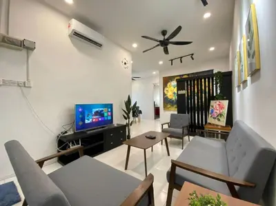 a living room with a couch and a flat screen tv at Cozy House 3Room8Pax`````LUNAS in Lunas