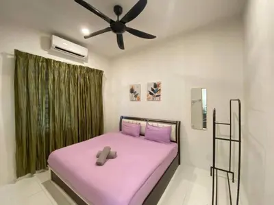 a bedroom with a pink bed with a ceiling fan at Cozy House 3Room8Pax`````LUNAS in Lunas