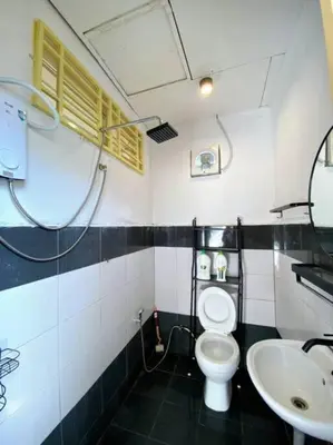a bathroom with a toilet and a sink at Cozy House 3Room8Pax`````LUNAS in Lunas