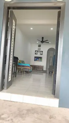 an open door to a living room with a couch at Homestay Manjung HZ in Sitiawan