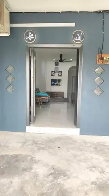 a hallway of a house with a blue wall at Homestay Manjung HZ in Sitiawan