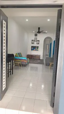 a living room with a couch and chairs in a room at Homestay Manjung HZ in Sitiawan