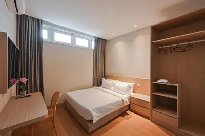 a small room with a bed and a table and a desk at Simple Sanctuary Tanjung Tokong in Tanjung Bungah