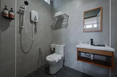 a bathroom with a shower and a toilet and a sink at Simple Sanctuary Tanjung Tokong in Tanjung Bungah