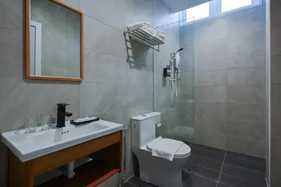 a bathroom with a toilet and a sink and a shower at Simple Sanctuary Tanjung Tokong in Tanjung Bungah