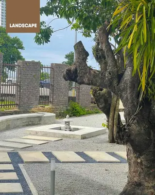 a tree in front of a fountain in a park at Simple Sanctuary Tanjung Tokong in Tanjung Bungah