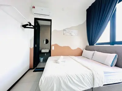 a bedroom with a bed and a blue curtain at 12 pax luxury seaview infinity pool apartment in Jelutong