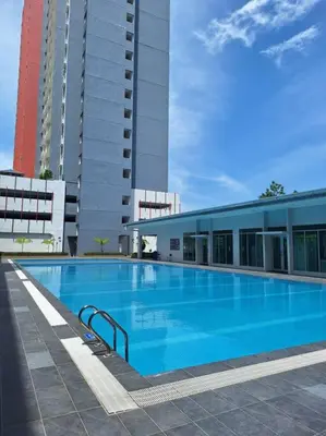 a large swimming pool in front of a building at Anderson Zara Homestay in Ipoh