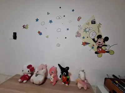 a group of stuffed animals sitting on a shelf against a wall at Anderson Zara Homestay in Ipoh