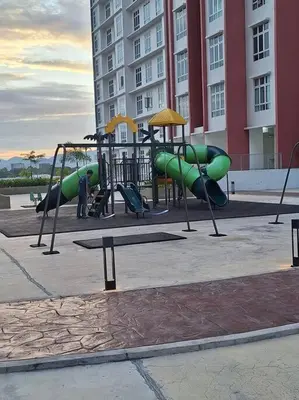 a playground with green play equipment in front of a building at Anderson Zara Homestay in Ipoh