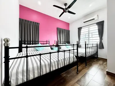 a bedroom with two beds and a pink wall at i Homes Villa 2 at Ipoh Town 16 Guest in Ipoh