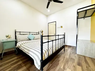 a bedroom with a black bed and a mirror at i Homes Villa 2 at Ipoh Town 16 Guest in Ipoh