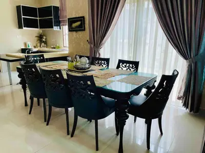 a dining room table and chairs in a kitchen at Bungalow in exclusive area in Nibung Tebal