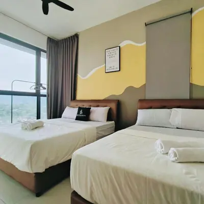 two beds in a hotel room with a window at 2 bed room 5 queen bed luxury sea view apartment in Jelutong