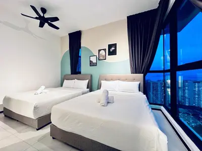 two beds in a room with a large window at 2 bed room 5 queen bed luxury sea view apartment in Jelutong