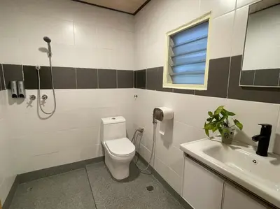 a bathroom with a toilet and a sink at Manson Goat Cottage in Cameron Highlands