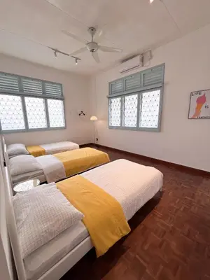 two beds in a room with two windows at Canning 48 in Ipoh