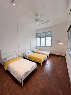 a room with three beds and a ceiling fan at Canning 48 in Ipoh