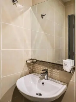 a bathroom with a sink and a mirror at Sunrise Serenity at Palas Horizon Residence in Brinchang