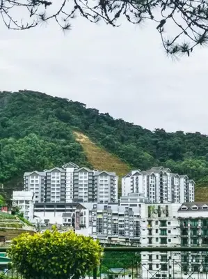 a large apartment building in front of a mountain at Sunrise Serenity at Palas Horizon Residence in Brinchang